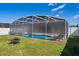 A beautiful screened-in pool area with lounge chairs, perfect for relaxation and outdoor entertainment at 15501 Markham Dr, Clermont, FL 34714