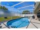 Outdoor swimming pool with a screened-in enclosure, offering a private oasis at 15501 Markham Dr, Clermont, FL 34714