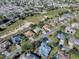 Wide aerial view of the golf community featuring houses and a well-manicured golf course at 1573 Blenheim Trl, The Villages, FL 32162