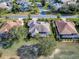 Aerial view of a house in a golf community that features manicured lawns and mature trees at 1573 Blenheim Trl, The Villages, FL 32162