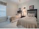 Bedroom showcasing twin beds, neutral decor, carpeted floor, and decorative artwork at 1573 Blenheim Trl, The Villages, FL 32162