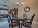 Dining room area featuring glass top table and chair set and view into the living room at 1573 Blenheim Trl, The Villages, FL 32162