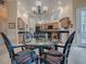 Dining room featuring a glass-top table, unique chairs, and direct access to the kitchen at 1573 Blenheim Trl, The Villages, FL 32162