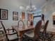 Open-concept dining area featuring a chandelier and easy access to living areas at 1573 Blenheim Trl, The Villages, FL 32162