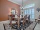 Elegant dining room with wainscoting, chandelier and large shuttered window at 1573 Blenheim Trl, The Villages, FL 32162