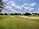 Expansive golf course view with sand traps and lush green fairways under a blue sky at 1573 Blenheim Trl, The Villages, FL 32162