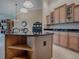 Bright kitchen island with granite countertop with adjacent cabinets, breakfast nook in the background at 1573 Blenheim Trl, The Villages, FL 32162