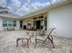 Screened lanai featuring stone flooring and outdoor seating, perfect for entertaining at 1573 Blenheim Trl, The Villages, FL 32162