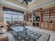 Living room featuring built-in bookcase, decorative vases and a ceiling fan at 1573 Blenheim Trl, The Villages, FL 32162