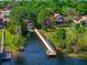 Aerial view of a waterfront house, featuring a private dock and a long driveway leading to a beautiful residential property at 2029 Stefano Ct, Mount Dora, FL 32757