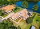 Stunning aerial view of a lakeside home featuring lush landscaping, a pool, and a private backyard at 2029 Stefano Ct, Mount Dora, FL 32757
