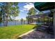 Backyard with paved patio with lawn chairs, screened pool, and lake view at 2029 Stefano Ct, Mount Dora, FL 32757
