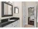 Bathroom with granite countertops, white cabinets, and an open door leading to the connected bedroom offers a serene experience at 2029 Stefano Ct, Mount Dora, FL 32757