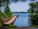 Picturesque wooden dock on a serene lake, perfect for boating and fishing, with a concrete ramp for easy access at 2029 Stefano Ct, Mount Dora, FL 32757