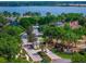 Aerial view of the gated entrance to a lakeside community with lush landscaping at 2029 Stefano Ct, Mount Dora, FL 32757