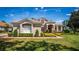A charming home featuring a tile roof, well-maintained landscaping, and a welcoming front entrance at 2029 Stefano Ct, Mount Dora, FL 32757