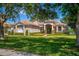 Beautiful single-story home with manicured front yard and large windows bringing in natural light at 2029 Stefano Ct, Mount Dora, FL 32757