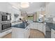 Contemporary kitchen with white cabinets, blue countertops, an island, stainless appliances, and marble backsplash at 2029 Stefano Ct, Mount Dora, FL 32757
