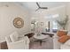 Bright living room with high ceilings, ceiling fan, and view to a lake at 2029 Stefano Ct, Mount Dora, FL 32757
