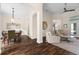Open concept living room with hardwood floors, neutral decor, and ample natural light at 2029 Stefano Ct, Mount Dora, FL 32757