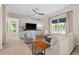 Spacious living room with neutral furniture, built-in storage, a ceiling fan, and a view of the lake at 2029 Stefano Ct, Mount Dora, FL 32757