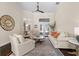Bright living room with high ceilings, ceiling fan, and view to a lake at 2029 Stefano Ct, Mount Dora, FL 32757