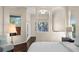 Bright and airy main bedroom with large windows and a view of the water offers a serene and peaceful setting at 2029 Stefano Ct, Mount Dora, FL 32757