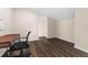 Empty office with neutral wall color and dark flooring, complemented by a modern desk and chair at 2029 Stefano Ct, Mount Dora, FL 32757