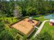 Well-kept community playground with swings and slides, nestled in a green, fenced area for to enjoy at 2029 Stefano Ct, Mount Dora, FL 32757