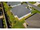 Aerial view of a home showcasing lush landscaping, manicured lawn, and a well-maintained backyard at 2170 Biller Cir, The Villages, FL 32163