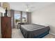 Spacious bedroom with a dresser, bedside table, and a ceiling fan at 2170 Biller Cir, The Villages, FL 32163
