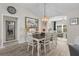 Bright dining room with natural light features stylish light fixture and doorway to the living room at 2170 Biller Cir, The Villages, FL 32163