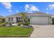 Charming single-story home with a well-manicured lawn and a two car garage at 2170 Biller Cir, The Villages, FL 32163