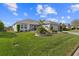 Beautifully landscaped front yard with lush green grass and decorative landscaping at 2170 Biller Cir, The Villages, FL 32163