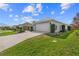 Driveway and two car garage with manicured landscaping at 2170 Biller Cir, The Villages, FL 32163