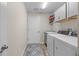 Functional laundry room featuring a sink, washer, dryer, and ample storage at 2170 Biller Cir, The Villages, FL 32163