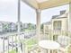 Outdoor balcony with table and chairs overlooking the community and surrounding street at 2310 Silver Palm Dr # 301, Kissimmee, FL 34747