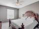 Cozy bedroom featuring a decorative wooden bed frame, carpet, and a bright window at 2310 Silver Palm Dr # 301, Kissimmee, FL 34747