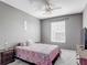 Serene bedroom with soft lighting, patterned bedding, a comfortable bed and dresser, and window view at 2310 Silver Palm Dr # 301, Kissimmee, FL 34747