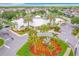 Aerial shot of the clubhouse, showcasing its design and landscaping with circular flower bed and palm trees at 2310 Silver Palm Dr # 301, Kissimmee, FL 34747