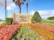 Beautiful Windsor Palms gated resort community sign amidst colorful flowers, creating a welcoming entrance at 2310 Silver Palm Dr # 301, Kissimmee, FL 34747