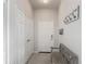 Welcoming entryway featuring coat closet, hall tree and a rustic bench at 2310 Silver Palm Dr # 301, Kissimmee, FL 34747