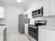 Modern kitchen with stainless steel appliances, white cabinetry, and sleek countertops at 2310 Silver Palm Dr # 301, Kissimmee, FL 34747