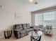 Cozy living room with plush sofa, decorative chairs, glass tables, and natural light from the window at 2310 Silver Palm Dr # 301, Kissimmee, FL 34747