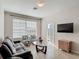 Bright living room with large window, tiled floors, and comfortable furnishings at 2310 Silver Palm Dr # 301, Kissimmee, FL 34747