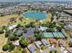 Aerial view showing neighborhood amenities including golf course, pool, and tennis courts at 2461 Merida Cir, The Villages, FL 32162