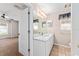 En suite bathroom with large countertop vanity, window, and tile flooring at 2461 Merida Cir, The Villages, FL 32162