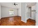 Bedroom with hardwood floors, ceiling fan, and closet system for storage at 2461 Merida Cir, The Villages, FL 32162