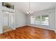 Dining room features hardwood floors, large windows, modern lighting, and stylish decor at 2461 Merida Cir, The Villages, FL 32162