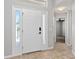Bright foyer with tile flooring, a front door with sidelights, and a glimpse into adjacent rooms at 2461 Merida Cir, The Villages, FL 32162